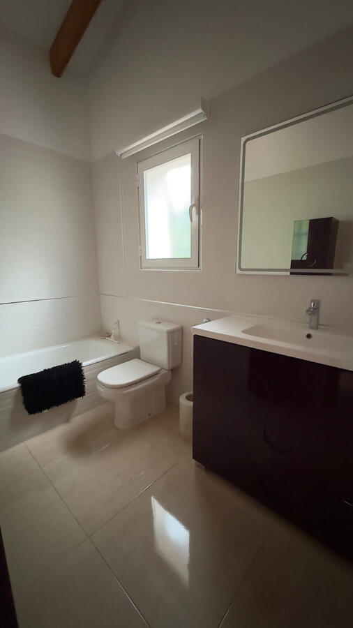 Ensuite bathroom with bath and shower head